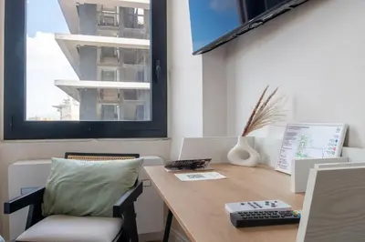an office with a desk and a chair and a window at Cunabu Apartments in Rome