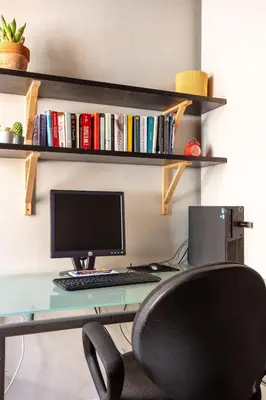a desk with a computer monitor and a chair at BQA San Crisogono Apartments Rome-Trastevere in Rome