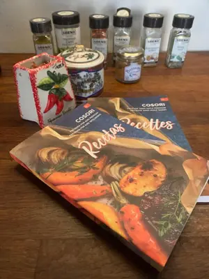 a magazine sitting on a table with some spices at BQA San Crisogono Apartments Rome-Trastevere in Rome