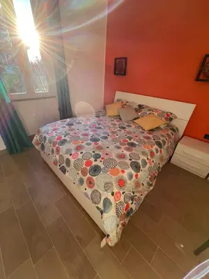 a bedroom with a bed with a comforter on it at Zangàl al Vaticano - Metro Cornelia in Rome
