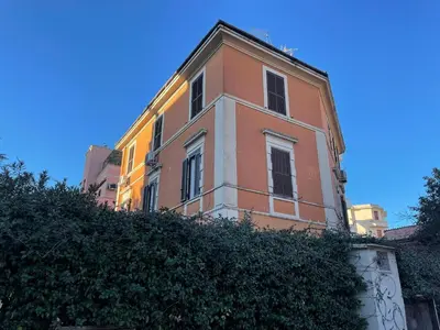 a pink building with a blue sky in the background at Zangàl al Vaticano - Metro Cornelia in Rome