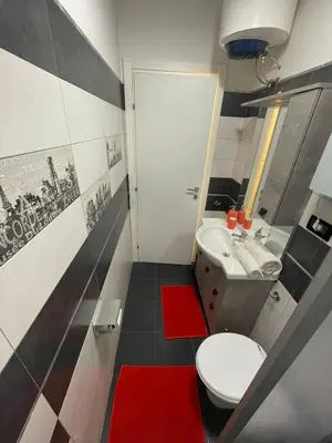 a bathroom with a white toilet and a sink at Zangàl al Vaticano - Metro Cornelia in Rome