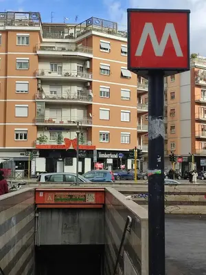 a sign on a pole in front of a building at Zangàl al Vaticano - Metro Cornelia in Rome