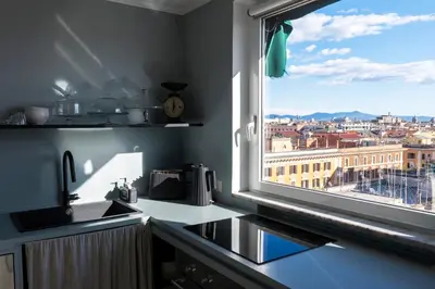 a kitchen with a window with a view of a city at LA VUE DE PAULINE in Rome