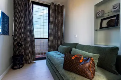 a living room with a couch with a purse on it at LA VUE DE PAULINE in Rome