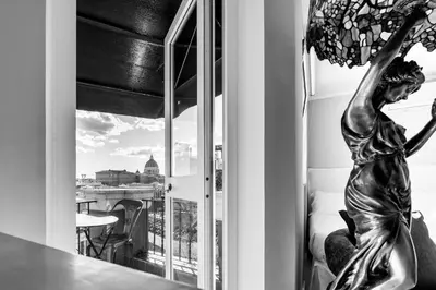 a statue of a woman looking out of a window at LA VUE DE PAULINE in Rome
