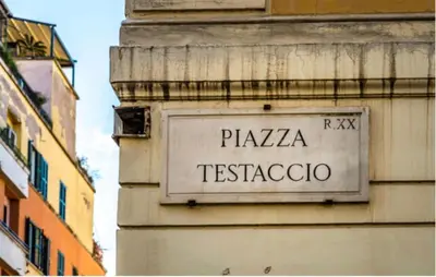 a sign on the side of a building at DOMVS Ginori Testaccio in Rome