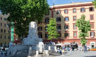a statue in front of a building in a city at DOMVS Ginori Testaccio in Rome