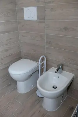 a bathroom with a toilet and a sink at DOMVS Ginori Testaccio in Rome
