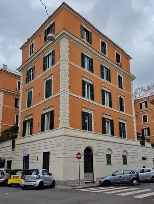 a large building with cars parked in front of it at DOMVS Ginori Testaccio in Rome