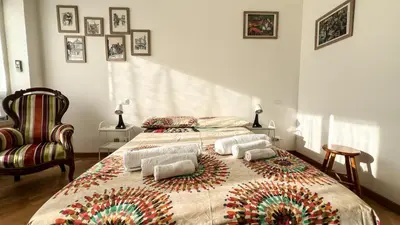a bedroom with a large bed with two pillows on it at BaccaLia Home in Rome