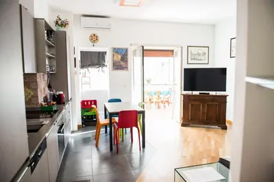 a kitchen with a table and chairs and a television at BaccaLia Home in Rome