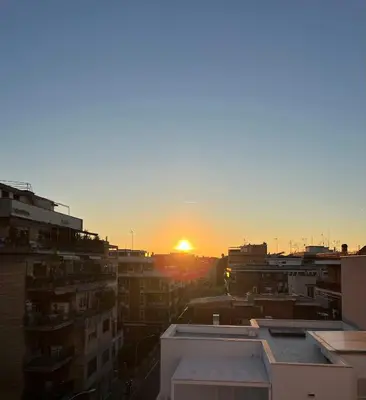 a view of the sunset from a city at BaccaLia Home in Rome