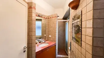 a bathroom with a sink and a mirror at BaccaLia Home in Rome