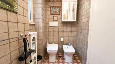 a small bathroom with a toilet and a sink at BaccaLia Home in Rome