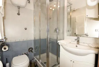 a bathroom with a shower and a toilet and a sink at San Pietro's Home - Guesthouse in Rome
