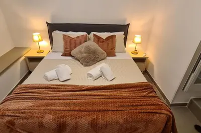 a bedroom with a large bed with two pillows at MON CHERI COLOSSEO in Rome