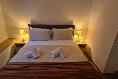 a bedroom with a bed with two towels on it at MON CHERI COLOSSEO in Rome