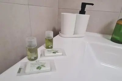 a bathroom counter with two bottles of essential oils on it at MON CHERI COLOSSEO in Rome