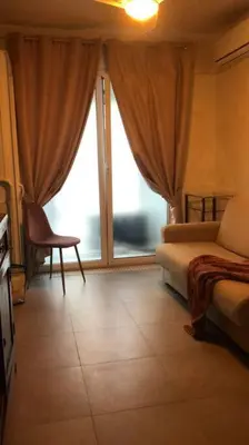 a room with a bed and a chair and a window at MON CHERI COLOSSEO in Rome