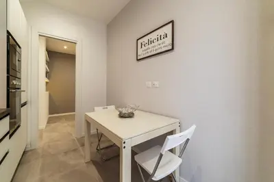 a dining room with a white table and two chairs at GuestHost - Monteverde Quattro Venti Apartment in Rome