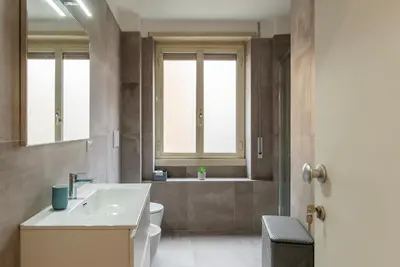 a bathroom with a sink and a toilet and a tub at GuestHost - Monteverde Quattro Venti Apartment in Rome