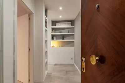 a room with a door and a hallway with shelves at GuestHost - Monteverde Quattro Venti Apartment in Rome