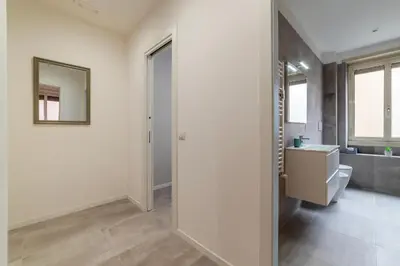 a bathroom with a toilet and a sink and a mirror at GuestHost - Monteverde Quattro Venti Apartment in Rome