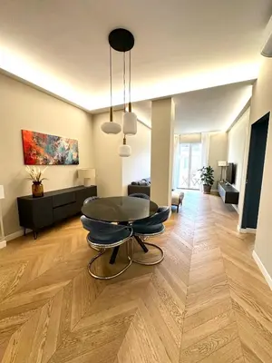 a living room with a table in the middle of a room at Giulia’s Corner in Rome