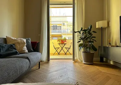 a living room with a couch and a sliding glass door at Giulia’s Corner in Rome