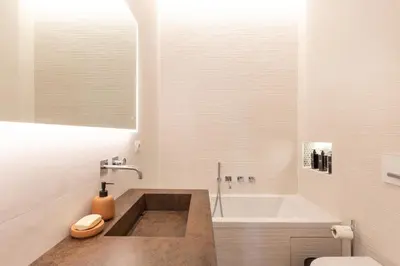 a bathroom with a tub and a toilet and a sink at Adventura Penthouse in Rome