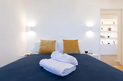 a blue bed with towels on top of it at Adventura Penthouse in Rome