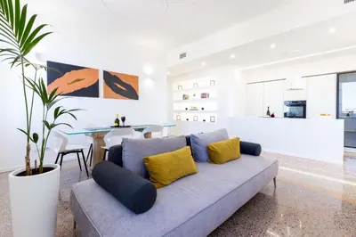 a living room with a couch and a table at Adventura Penthouse in Rome
