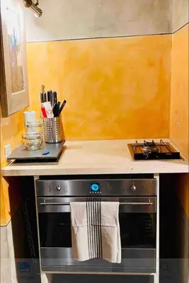 a kitchen with a stove with a counter top at Apartamento loft ingresso independente central zona san lorenzo in Rome