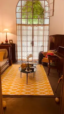 a living room with a table and a large window at Apartamento loft ingresso independente central zona san lorenzo in Rome