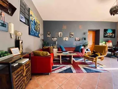 a living room with a red couch and a red chair at Guest Art Trastevere Station with AC in Rome