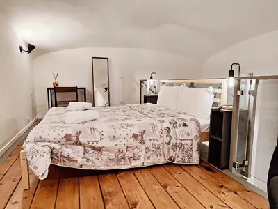 a bedroom with a bed with a blanket on it at Testaccio Industrial Loft in Rome