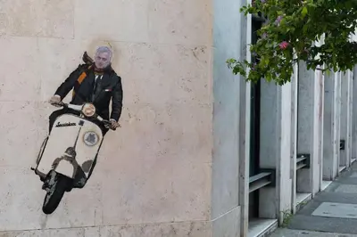 a painting of a man on a scooter on a wall at Testaccio Industrial Loft in Rome