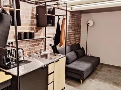 a kitchen with a couch and a sink in a room at Testaccio Industrial Loft in Rome