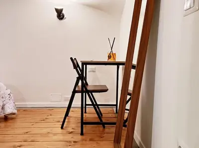 a small table with a chair in a room at Testaccio Industrial Loft in Rome