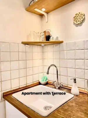 a kitchen sink with a sign that reads experiment with temperature at Vacanze Romane Colosseum in Rome