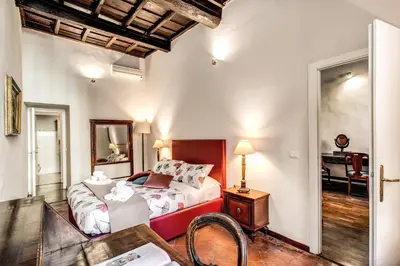 a bedroom with a bed and a table and a mirror at Borgo Pio Passetto Papale in Rome