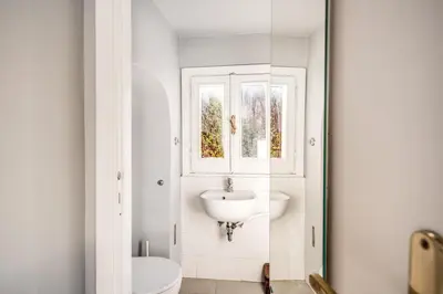a white bathroom with a sink and a window at Borgo Pio Passetto Papale in Rome