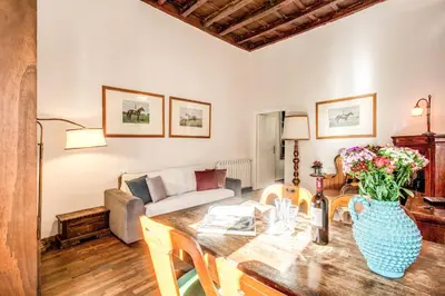 a living room with a table and a couch at Borgo Pio Passetto Papale in Rome