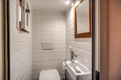 a bathroom with a toilet and a sink and a mirror at Cartari Apartment in Rome