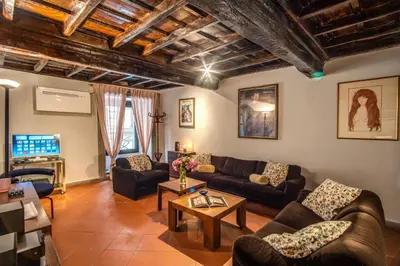 a living room with couches and a tv at Cartari Apartment in Rome
