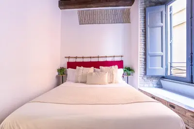 a bedroom with a large bed with a red headboard at FIORE home Rome Center Campo dè Fiori in Rome