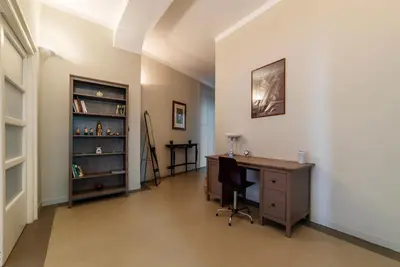 an office with a desk and a book shelf at GuestHost - Piazza Bainsizza Elegant Apartment in Rome