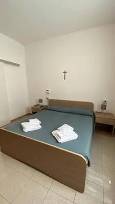 a bedroom with a bed with towels on it at Casa Per Ferie Casa Cabrini in Rome
