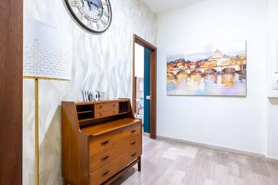 a room with a dresser and a clock on the wall at Vista Indimenticabile sulla Cupola di S. Pietro in Rome
